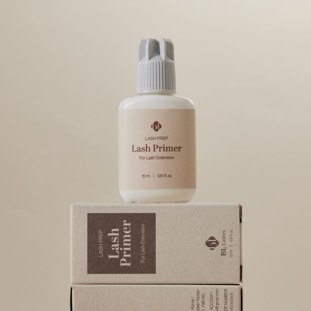 BL Lashes Lash Prep Lash Primer 15ml bottle resting on top of its stacked packaging boxes.